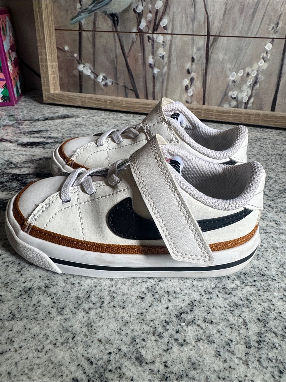 Nike Kids White Sneakers with Black Swoosh and Brown Accent